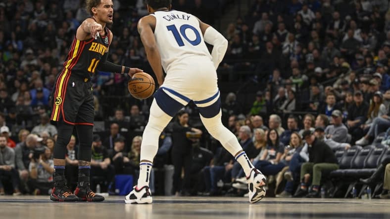 Mar 22, 2023; Minneapolis, Minnesota, USA;  Atlanta Hawks guard Trae Young (11) calls a play as Minnesota Timberwolves guard Mike Conley (10) defends in the second quarter at Target Center. Mandatory Credit: Nick Wosika-USA TODAY Sports