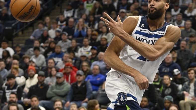 Mar 22, 2023; Minneapolis, Minnesota, USA;  Minnesota Timberwolves center Rudy Gobert (27) saves the ball from going out of bounds against the Atlanta Hawks in the second quarter at Target Center. Mandatory Credit: Nick Wosika-USA TODAY Sports