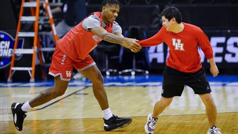 Mar 23, 2023; Kansas City, MO, USA; Houston Cougars guard Marcus Sasser (0) grabs a team trainer during a practice session at T-Mobile Center. Mandatory Credit: Jay Biggerstaff-USA TODAY Sports
