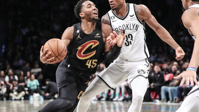 Mar 23, 2023; Brooklyn, New York, USA; Cleveland Cavaliers guard Donovan Mitchell (45) looks to drive past Brooklyn Nets center Nic Claxton (33) in the second quarter at Barclays Center. Mandatory Credit: Wendell Cruz-USA TODAY Sports