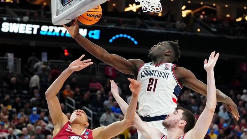 Mar 23, 2023; Las Vegas, NV, USA; UConn Huskies forward Adama Sanogo (21) grabs a rebound against Arkansas Razorbacks guard Jordan Walsh (13) during the second half at T-Mobile Arena. Mandatory Credit: Stephen R. Sylvanie-USA TODAY Sports