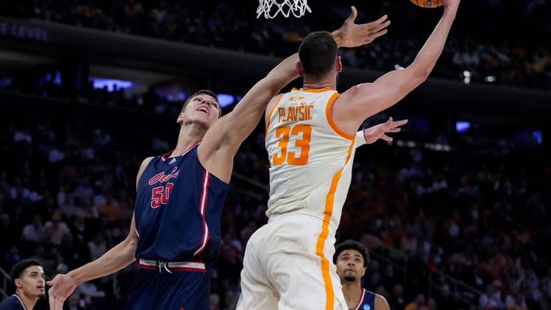 Mar 23, 2023; New York, NY, USA;  Tennessee Volunteers forward Uros Plavsic (33) drives to the basket against Florida Atlantic Owls center Vladislav Goldin (50) in the first half at Madison Square Garden. Mandatory Credit: Robert Deutsch-USA TODAY Sports
