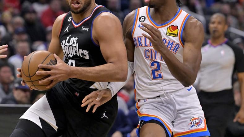 Mar 23, 2023; Los Angeles, California, USA; Los Angeles Clippers guard Eric Gordon (10) has the ball stropped by Oklahoma City Thunder guard Shai Gilgeous-Alexander (2) as he moves to the basket in the first half at Crypto.com Arena. Mandatory Credit: Jayne Kamin-Oncea-USA TODAY Sports