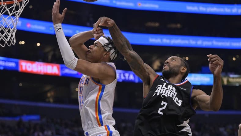 Mar 23, 2023; Los Angeles, California, USA; Los Angeles Clippers forward Kawhi Leonard (2) knocks the ball from Oklahoma City Thunder forward Ousmane Dieng (13) as he goes up for a shot in the second half at Crypto.com Arena. Mandatory Credit: Jayne Kamin-Oncea-USA TODAY Sports
