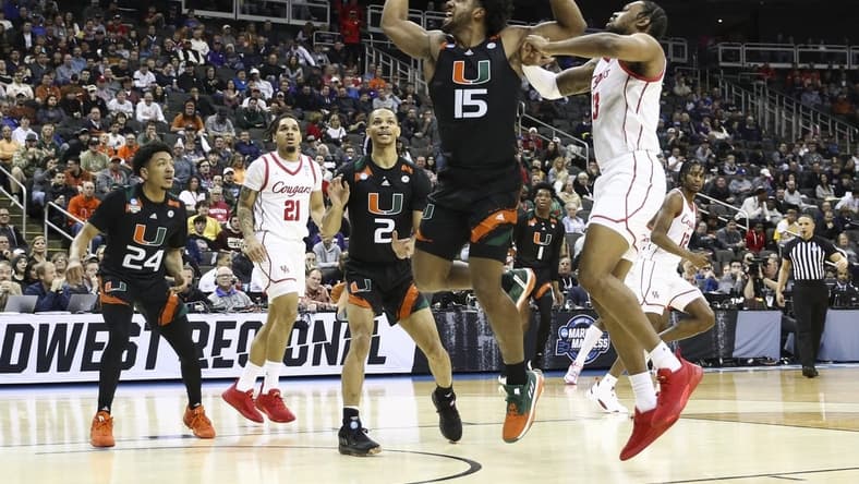 Mar 24, 2023; Kansas City, MO, USA; Miami Hurricanes forward Norchad Omier (15) and Houston Cougars forward J'Wan Roberts (13) fight for possession during the first half of an NCAA tournament Midwest Regional semifinal at T-Mobile Center. Mandatory Credit: William Purnell-USA TODAY Sports