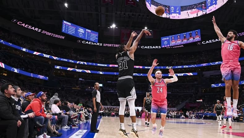 Mar 24, 2023; Washington, District of Columbia, USA; San Antonio Spurs forward Keita Bates-Diop (31) shoots as W forward Corey Kispert (24) and Washington Wizards forward Anthony Gill (16) slides to defend during the first half at Capital One Arena. Mandatory Credit: Tommy Gilligan-USA TODAY Sports