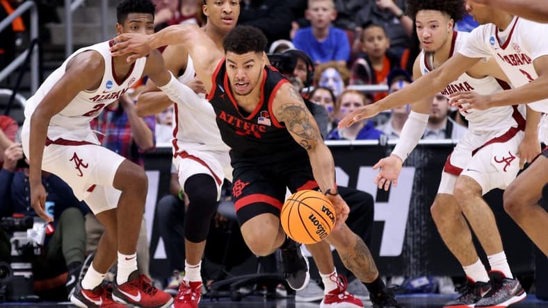 Mar 24, 2023; Louisville, KY, USA; San Diego State Aztecs guard Matt Bradley (20) dribbles away from Alabama Crimson Tide defenders during the second half of the NCAA tournament round of sixteen at KFC YUM! Center. Mandatory Credit: Jordan Prather-USA TODAY Sports