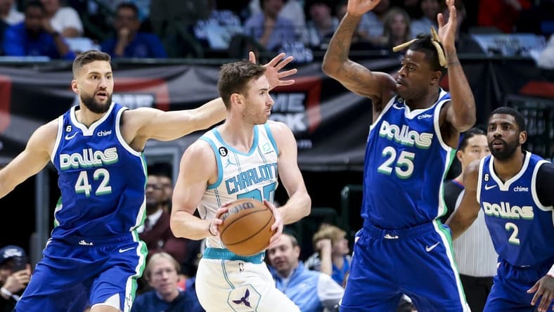Mar 24, 2023; Dallas, Texas, USA;  Charlotte Hornets forward Gordon Hayward (20) looks to pass as Dallas Mavericks forward Reggie Bullock (25) and Dallas Mavericks forward Maxi Kleber (42) defend during the first quarter at American Airlines Center. Mandatory Credit: Kevin Jairaj-USA TODAY Sports