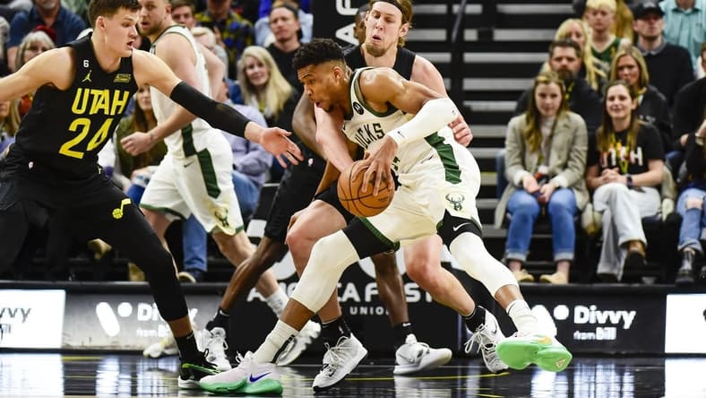 Mar 24, 2023; Salt Lake City, Utah, USA; Milwaukee Bucks forward Giannis Antetokounmpo (34) drives into Utah Jazz forward/center Kelly Olynyk (41) during the first half at Vivint Arena. Mandatory Credit: Christopher Creveling-USA TODAY Sports