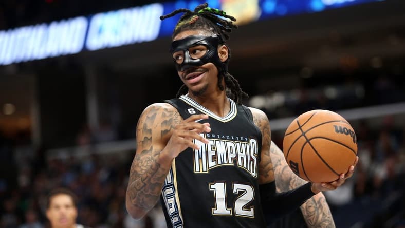 Mar 24, 2023; Memphis, Tennessee, USA; Memphis Grizzlies guard Ja Morant (12) collects the ball during the first half against the Houston Rockets at FedExForum. Mandatory Credit: Petre Thomas-USA TODAY Sports