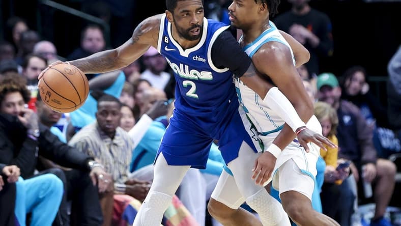 Mar 24, 2023; Dallas, Texas, USA; Dallas Mavericks guard Kyrie Irving (2) controls the ball as Charlotte Hornets guard Dennis Smith Jr. (8) defends during the fourth quarter at American Airlines Center. Mandatory Credit: Kevin Jairaj-USA TODAY Sports