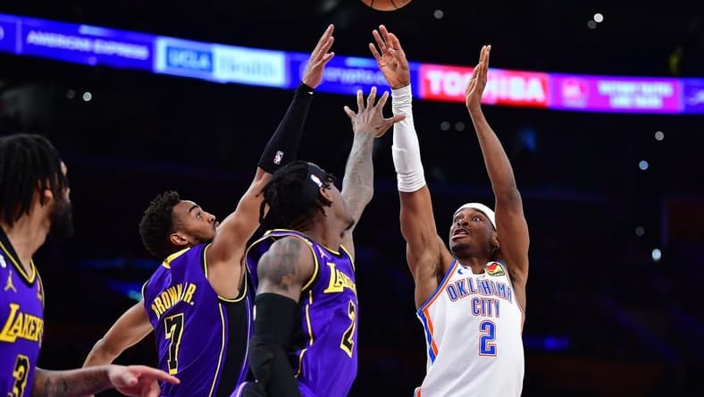 Mar 24, 2023; Los Angeles, California, USA; Oklahoma City Thunder guard Shai Gilgeous-Alexander (2) shoots agaisnt Los Angeles Lakers forward Jarred Vanderbilt (2) forward Troy Brown Jr. (7) during the first half at Crypto.com Arena. Mandatory Credit: Gary A. Vasquez-USA TODAY Sports