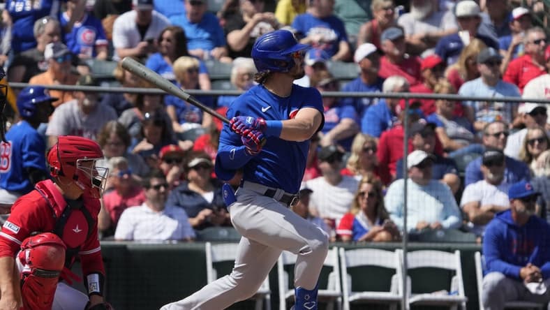 Mar 25, 2023; Tempe, Arizona, USA; Chicago Cubs third baseman Zach McKinstry (6) hits an RBI double against the Los Angeles Angels in the third inning at Tempe Diablo Stadium. Mandatory Credit: Rick Scuteri-USA TODAY Sports