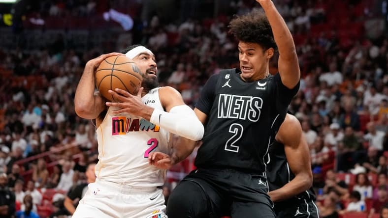 Mar 25, 2023; Miami, Florida, USA; Brooklyn Nets forward Cameron Johnson (2) fouls Miami Heat guard Gabe Vincent (2) during the first quarter at Miami-Dade Arena. Mandatory Credit: Rich Storry-USA TODAY Sports