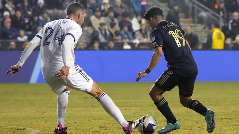 Mar 25, 2023; Philadelphia, Pennsylvania, USA; Philadelphia Union midfielder Joaquin Torres (19) and Orlando City SC defender Kyle Smith (24) battle for the ball in the first half at Subaru Park. Mandatory Credit: Gregory Fisher-USA TODAY Sports