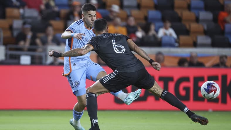 Mar 25, 2023; Houston, Texas, USA; New York City FC midfielder Gabriel Pereira (11) kicks the ball past Houston Dynamo midfielder Artur (6) during the first half at Shell Energy Stadium. Mandatory Credit: Troy Taormina-USA TODAY Sports