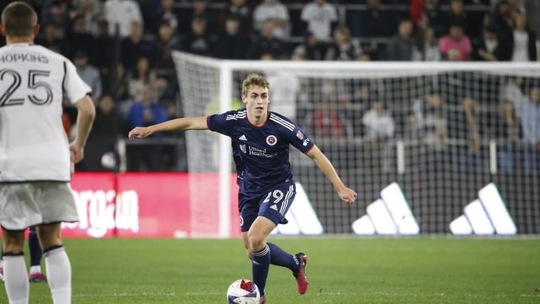 Mar 25, 2023; Washington, District of Columbia, USA; New England Revolution midfielder Noel Buck (29) controls the ball in front of D.C. United midfielder Jackson Hopkins (25) in the first half at Audi Field. Mandatory Credit: Amber Searls-USA TODAY Sports