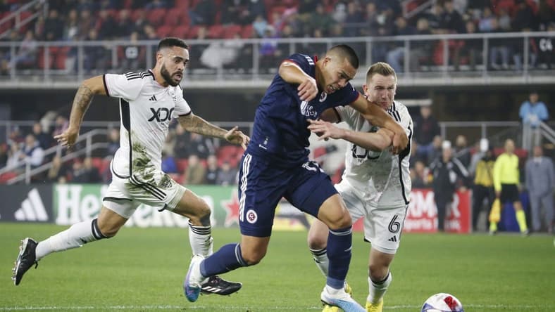 Mar 25, 2023; Washington, District of Columbia, USA; New England Revolution forward Bobby Wood (17) battles for the ball with D.C. United midfielder Russell Canouse (6) in the first half at Audi Field. Mandatory Credit: Amber Searls-USA TODAY Sports
