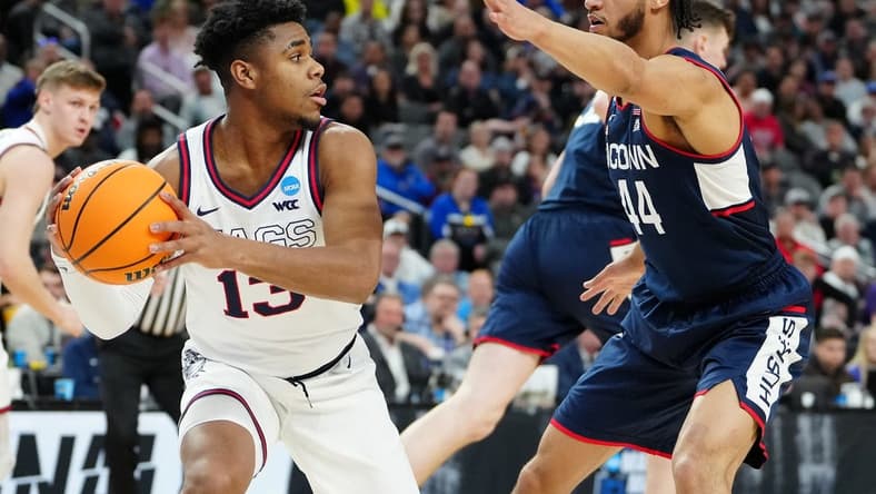Mar 25, 2023; Las Vegas, NV, USA; Gonzaga Bulldogs guard Malachi Smith (13) grabs a rebound against Connecticut Huskies guard Andre Jackson Jr. (44) during the first half in the NCAA tournament West Regional final at T-Mobile Arena. Mandatory Credit: Stephen R. Sylvanie-USA TODAY Sports