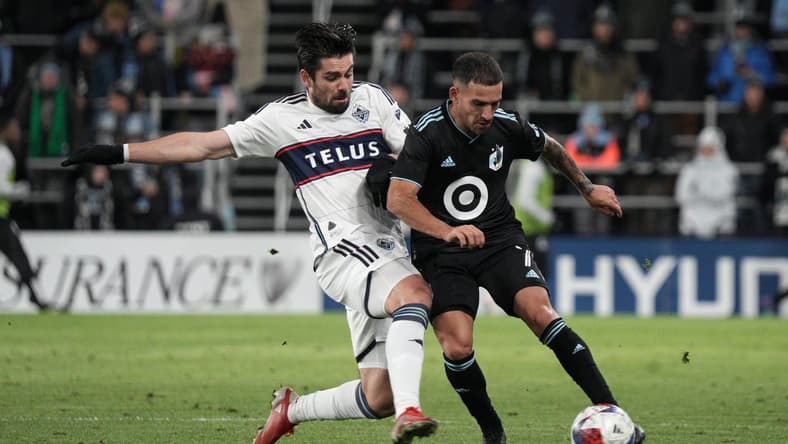 Mar 25, 2023; Saint Paul, Minnesota, USA; Minnesota United FC midfielder Franco Fragapane (7) in action against Vancouver Whitecaps forward Brian White (24) during the first half at Allianz Field. Mandatory Credit: Matt Blewett-USA TODAY Sports