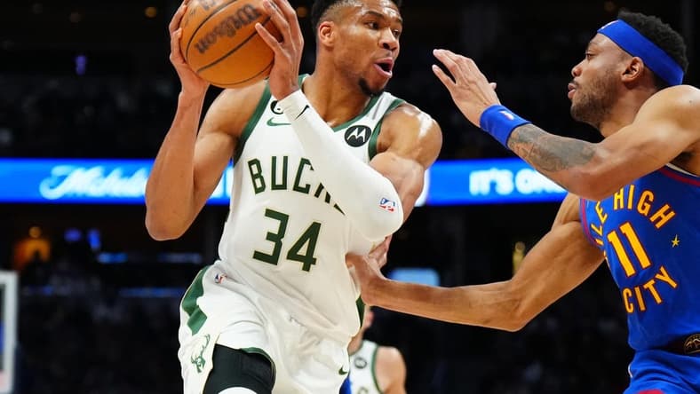 Mar 25, 2023; Denver, Colorado, USA; Milwaukee Bucks forward Giannis Antetokounmpo (34) and Denver Nuggets forward Bruce Brown (11) during the second quarter at Ball Arena. Mandatory Credit: Ron Chenoy-USA TODAY Sports