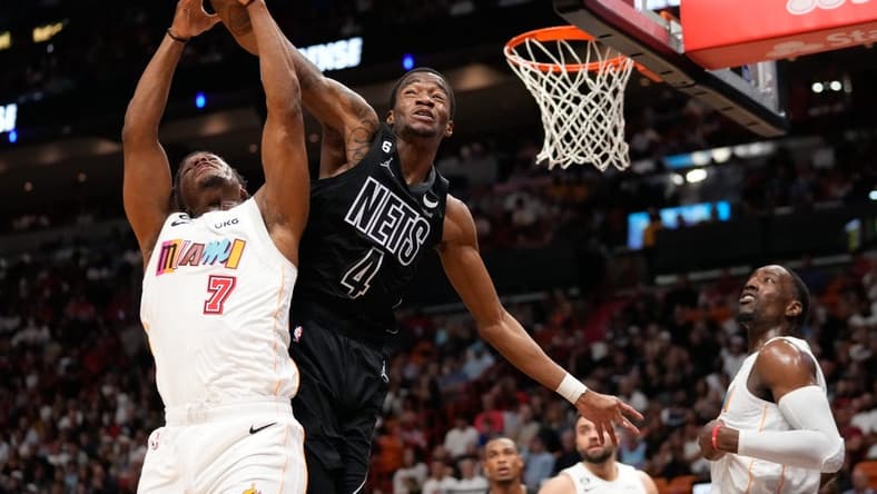 Mar 25, 2023; Miami, Florida, USA; Miami Heat guard Kyle Lowry (7) and Brooklyn Nets guard Edmond Sumner (4) compete for a rebound during the second half at Miami-Dade Arena. Mandatory Credit: Rich Storry-USA TODAY Sports