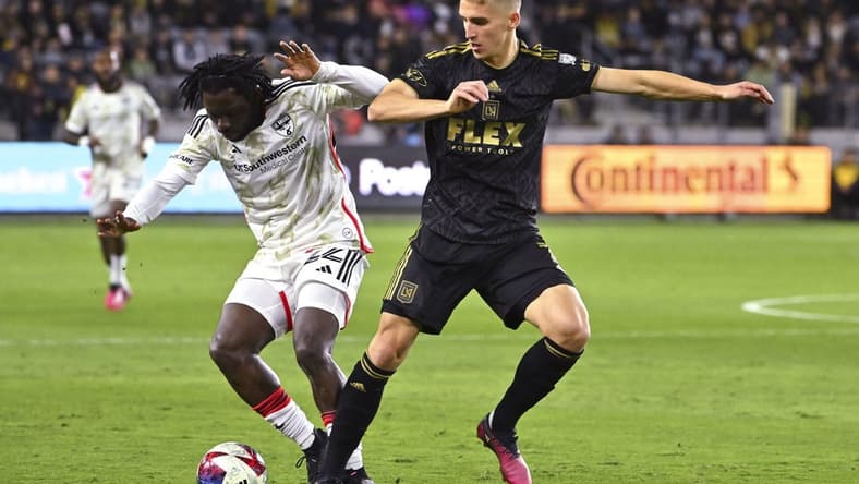 Mar 25, 2023; Los Angeles, California, USA; FC Dallas midfielder Ema Twumasi (22) and Los Angeles FC forward Stipe Biuk (7) battle for the ball in the first half at BMO Stadium. Mandatory Credit: Jayne Kamin-Oncea-USA TODAY Sports