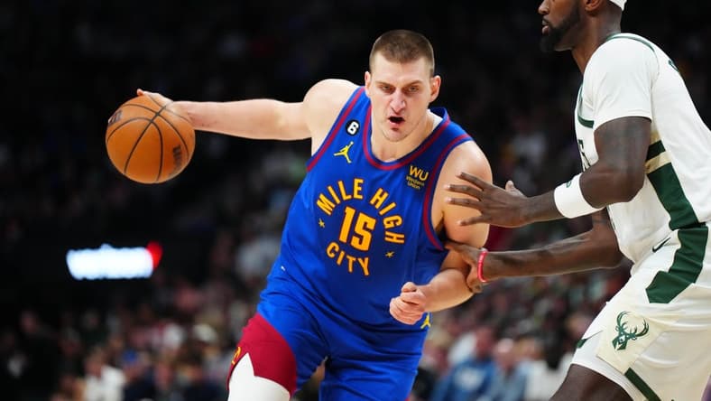 Mar 25, 2023; Denver, Colorado, USA; Denver Nuggets center Nikola Jokic (15) drives at Milwaukee Bucks forward Bobby Portis (9) during the second half at Ball Arena. Mandatory Credit: Ron Chenoy-USA TODAY Sports