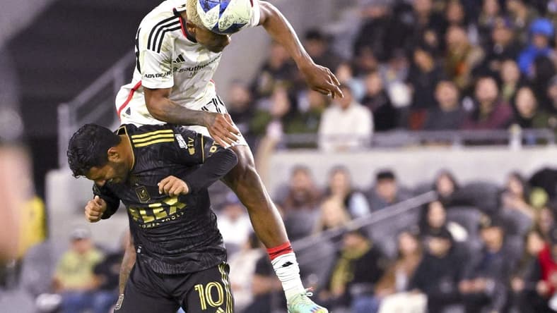 Mar 25, 2023; Los Angeles, California, USA; FC Dallas defender Nkosi Tafari (17) and Los Angeles FC forward Carlos Vela (10) go for the ball in the first half at BMO Stadium. Mandatory Credit: Jayne Kamin-Oncea-USA TODAY Sports