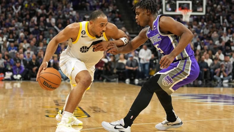 Mar 25, 2023; Sacramento, California, USA; Utah Jazz guard Talen Horton-Tucker (left) dribbles against Sacramento Kings guard Davion Mitchell (15) during the fourth quarter at Golden 1 Center. Mandatory Credit: Darren Yamashita-USA TODAY Sports