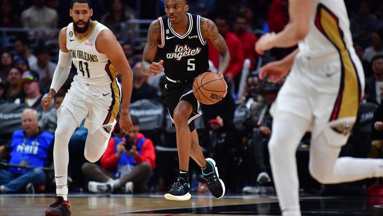 Mar 25, 2023; Los Angeles, California, USA; Los Angeles Clippers guard Bones Hyland (5) moves the ball ahead of New Orleans Pelicans forward Garrett Temple (41) during the second half at Crypto.com Arena. Mandatory Credit: Gary A. Vasquez-USA TODAY Sports