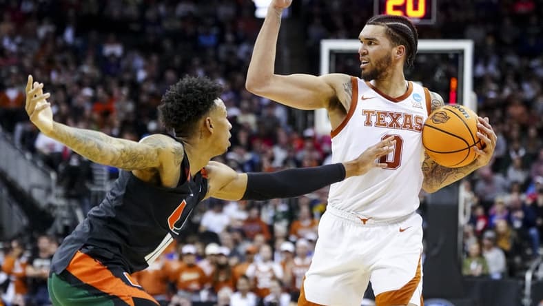 Mar 26, 2023; Kansas City, MO, USA;  Texas Longhorns forward Timmy Allen (0) controls the ball against Miami Hurricanes guard Jordan Miller (11) in the first half at the T-Mobile Center. Mandatory Credit: Jay Biggerstaff-USA TODAY Sports
