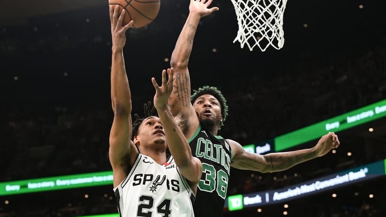 Mar 26, 2023; Boston, Massachusetts, USA; San Antonio Spurs guard Devin Vassell (24) attempts a layup against Boston Celtics guard Marcus Smart (36) during the first quarter at the TD Garden. Mandatory Credit: Brian Fluharty-USA TODAY Sports