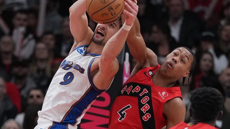 Mar 26, 2023; Toronto, Ontario, CAN; Toronto Raptors forward Scottie Barnes (4) battles for the ball with Washington Wizards forward Deni Avdija (9) during the second quarter at Scotiabank Arena. Mandatory Credit: Nick Turchiaro-USA TODAY Sports