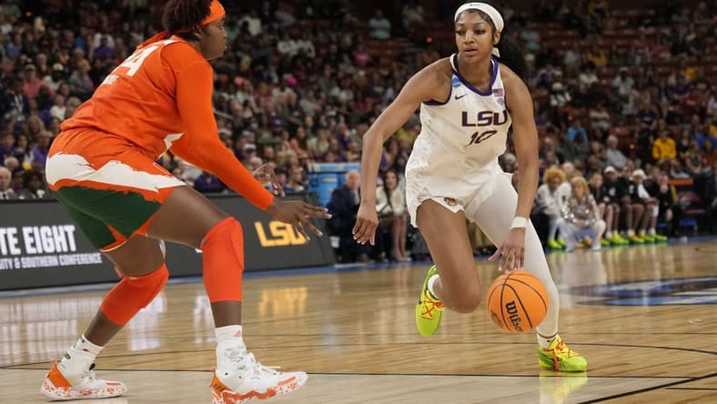 Mar 26, 2023; Greenville, SC, USA; LSU Lady Tigers forward Angel Reese (10) drives to the basket against Miami Hurricanes forward Kyla Oldacre (44) during the NCAA Women   s Tournament at Bon Secours Wellness Arena. Mandatory Credit: Jim Dedmon-USA TODAY Sports