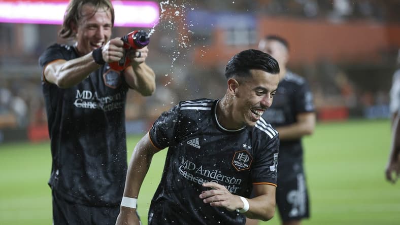 Mar 25, 2023; Houston, Texas, USA; Houston Dynamo midfielder Amine Bassi (8) is squirted with water after the match against the New York City FC at Shell Energy Stadium. Mandatory Credit: Troy Taormina-USA TODAY Sports