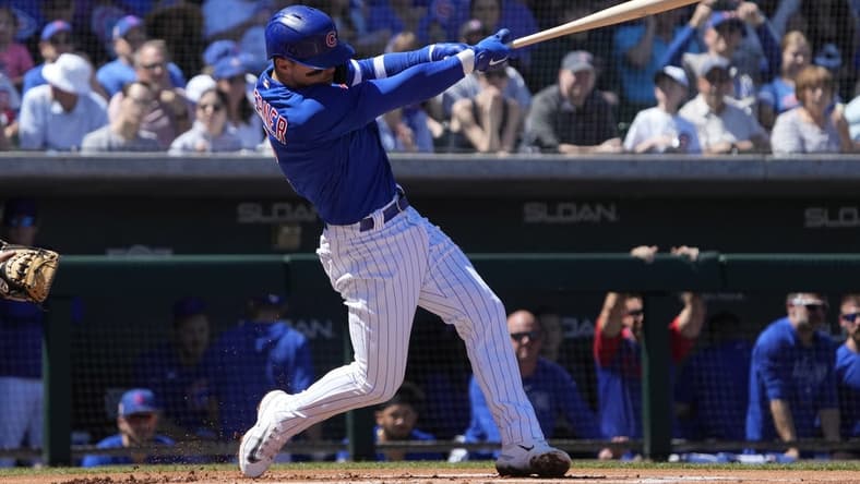 Mar 27, 2023; Mesa, Arizona, USA; Chicago Cubs shortstop Nico Hoerner (2) hits a single against the Chicago White Sox in the first inning at Sloan Park. Mandatory Credit: Rick Scuteri-USA TODAY Sports