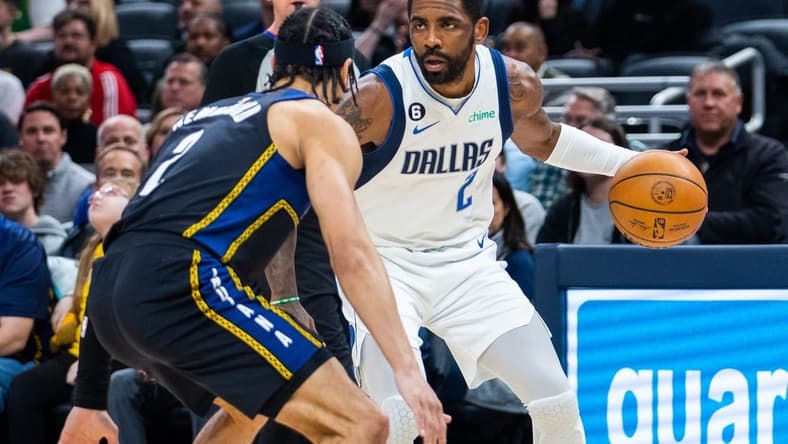 Mar 27, 2023; Indianapolis, Indiana, USA; Dallas Mavericks guard Kyrie Irving (2) dribbles the ball while Indiana Pacers guard Andrew Nembhard (2) defends in the first quarter at Gainbridge Fieldhouse. Mandatory Credit: Trevor Ruszkowski-USA TODAY Sports