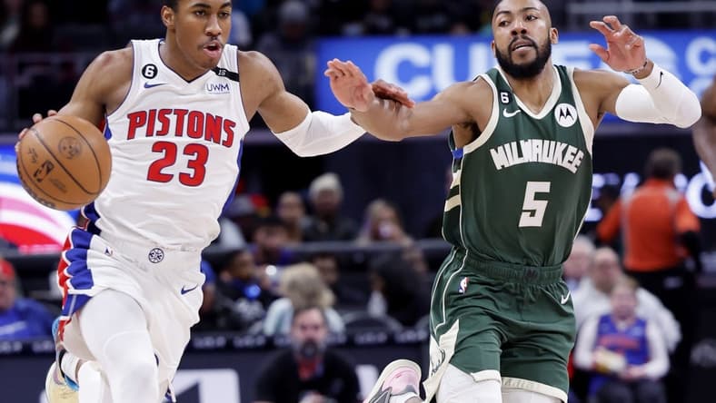 Mar 27, 2023; Detroit, Michigan, USA;  Detroit Pistons guard Jaden Ivey (23) dribbles on Milwaukee Bucks guard Jevon Carter (5) in the first half at Little Caesars Arena. Mandatory Credit: Rick Osentoski-USA TODAY Sports