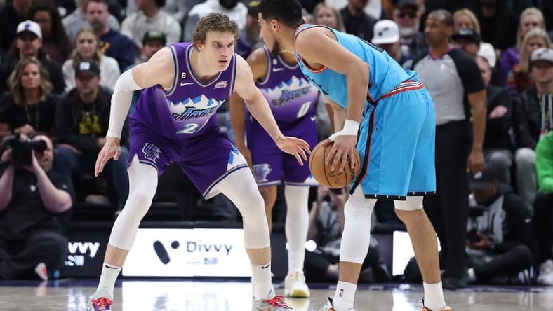 Mar 27, 2023; Salt Lake City, Utah, USA; Utah Jazz forward Lauri Markkanen (23) defends Phoenix Suns guard Devin Booker (1) in the second quarter at Vivint Arena. Mandatory Credit: Rob Gray-USA TODAY Sports