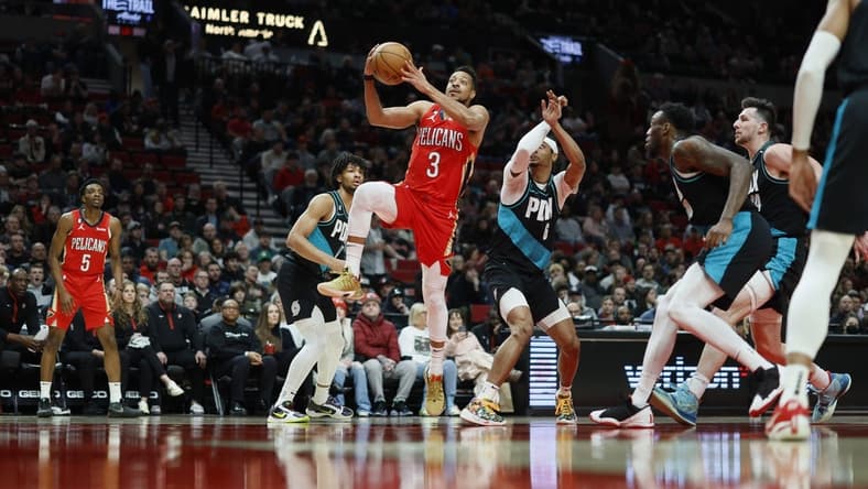 Mar 27, 2023; Portland, Oregon, USA; New Orleans Pelicans shooting guard CJ McCollum (3) drives to the basket past Portland Trail Blazers shooting guard Keon Johnson (6) during the first half at Moda Center. Mandatory Credit: Soobum Im-USA TODAY Sports