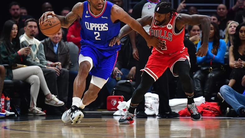 Mar 27, 2023; Los Angeles, California, USA; Los Angeles Clippers forward Kawhi Leonard (2) moves the ball against Chicago Bulls guard Patrick Beverley (21) during the first half at Crypto.com Arena. Mandatory Credit: Gary A. Vasquez-USA TODAY Sports