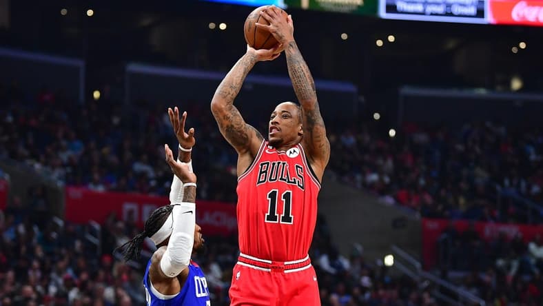 Mar 27, 2023; Los Angeles, California, USA; Chicago Bulls forward DeMar DeRozan (11) shoots against Los Angeles Clippers forward Robert Covington (23) during the first half at Crypto.com Arena. Mandatory Credit: Gary A. Vasquez-USA TODAY Sports