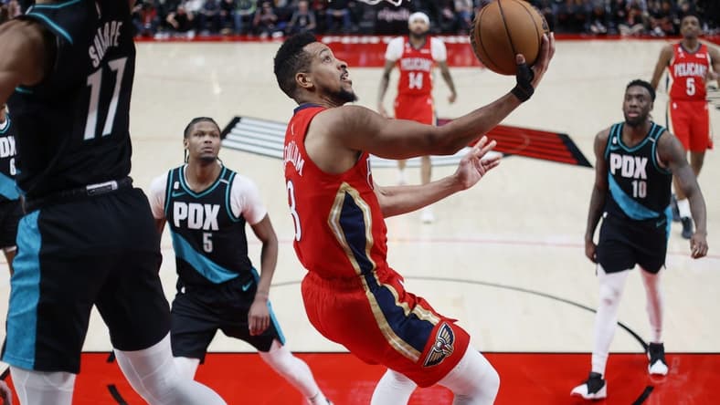 Mar 27, 2023; Portland, Oregon, USA; New Orleans Pelicans shooting guard CJ McCollum (3, right) shoots the ball past Portland Trail Blazers shooting guard Shaedon Sharpe (17) during the second half at Moda Center. Mandatory Credit: Soobum Im-USA TODAY Sports