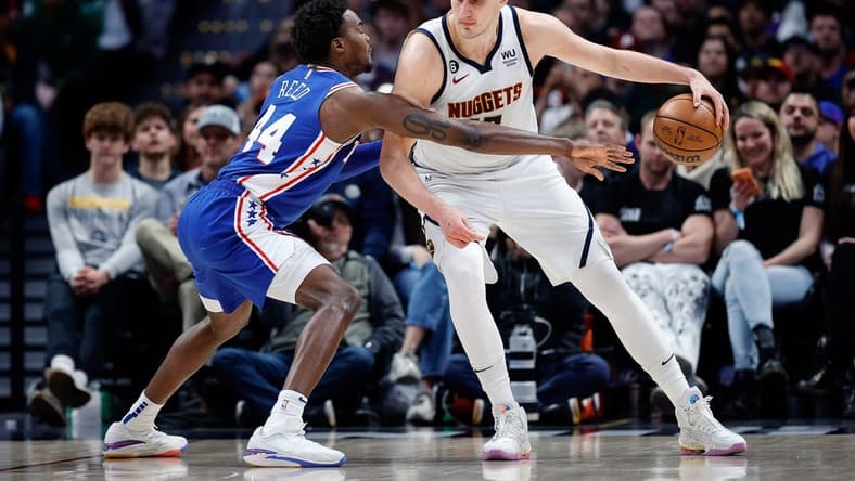 Mar 27, 2023; Denver, Colorado, USA; Denver Nuggets center Nikola Jokic (15) controls the ball as Philadelphia 76ers forward Paul Reed (44) guards in the third quarter at Ball Arena. Mandatory Credit: Isaiah J. Downing-USA TODAY Sports