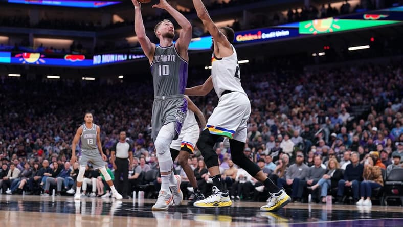 Mar 27, 2023; Sacramento, California, USA; Sacramento Kings forward Domantas Sabonis (10) shoots the ball next to Minnesota Timberwolves center Rudy Gobert (27) in the fourth quarter at the Golden 1 Center. Mandatory Credit: Cary Edmondson-USA TODAY Sports