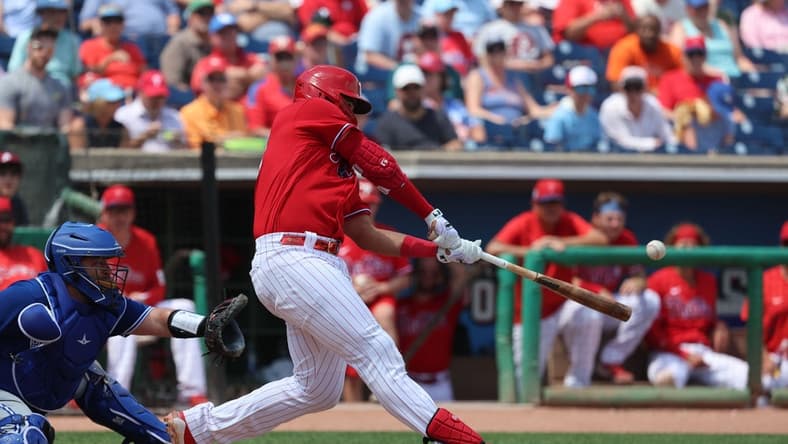 Mar 28, 2023; Clearwater, Florida, USA;  Philadelphia Phillies first baseman Darick Hall (24) singles during the fourth inning against the Toronto Blue Jays at BayCare Ballpark. Mandatory Credit: Kim Klement-USA TODAY Sports