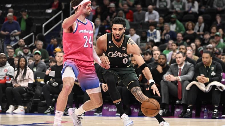 Mar 28, 2023; Washington, District of Columbia, USA; Boston Celtics forward Jayson Tatum (0) dribbles as Washington Wizards forward Corey Kispert (24) defends during the first half at Capital One Arena. Mandatory Credit: Brad Mills-USA TODAY Sports