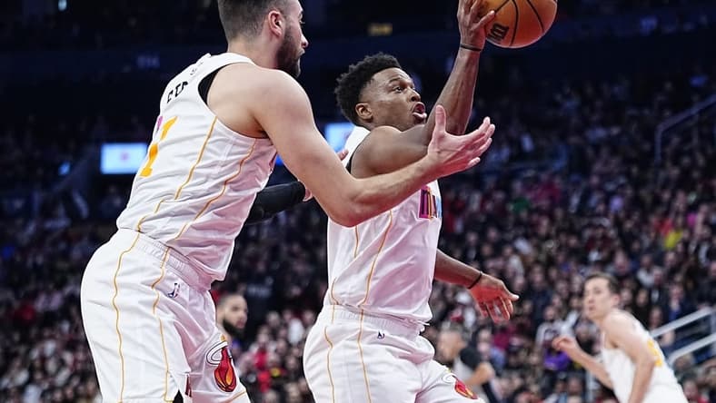 Mar 28, 2023; Toronto, Ontario, CAN; Miami Heat guard Kyle Lowry (7) and guard Max Strus (31) battle for a rebound against the Toronto Raptors during the second half at Scotiabank Arena. Mandatory Credit: John E. Sokolowski-USA TODAY Sports