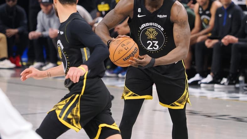 Mar 28, 2023; San Francisco, California, USA; Golden State Warriors center Draymond Green (23) controls the ball as he looks towards guard Stephen Curry (30) during the second quarter against the New Orleans Pelicans at Chase Center. Mandatory Credit: Kelley L Cox-USA TODAY Sports